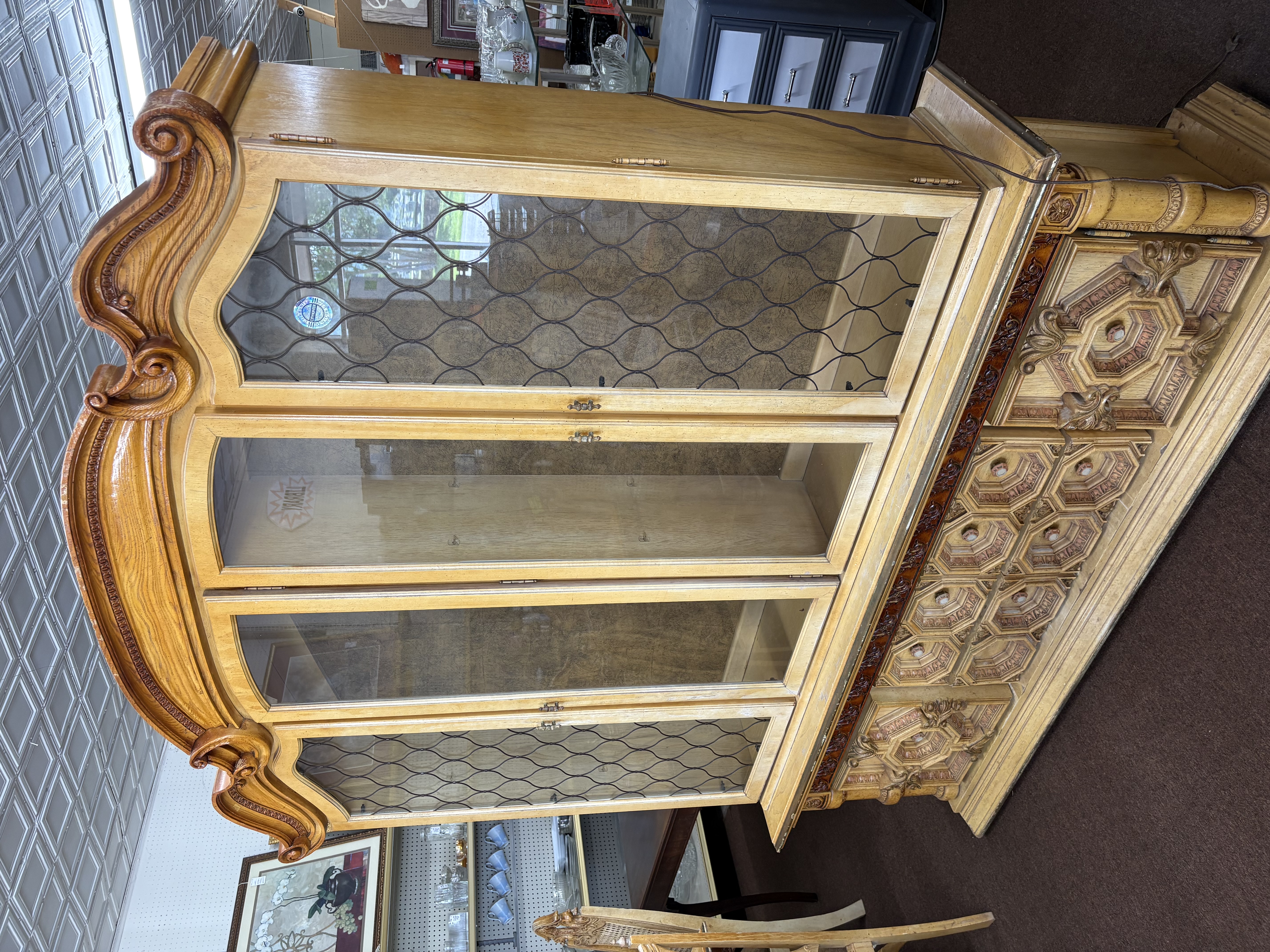 Ornate carved wood china cabinet with glass doors