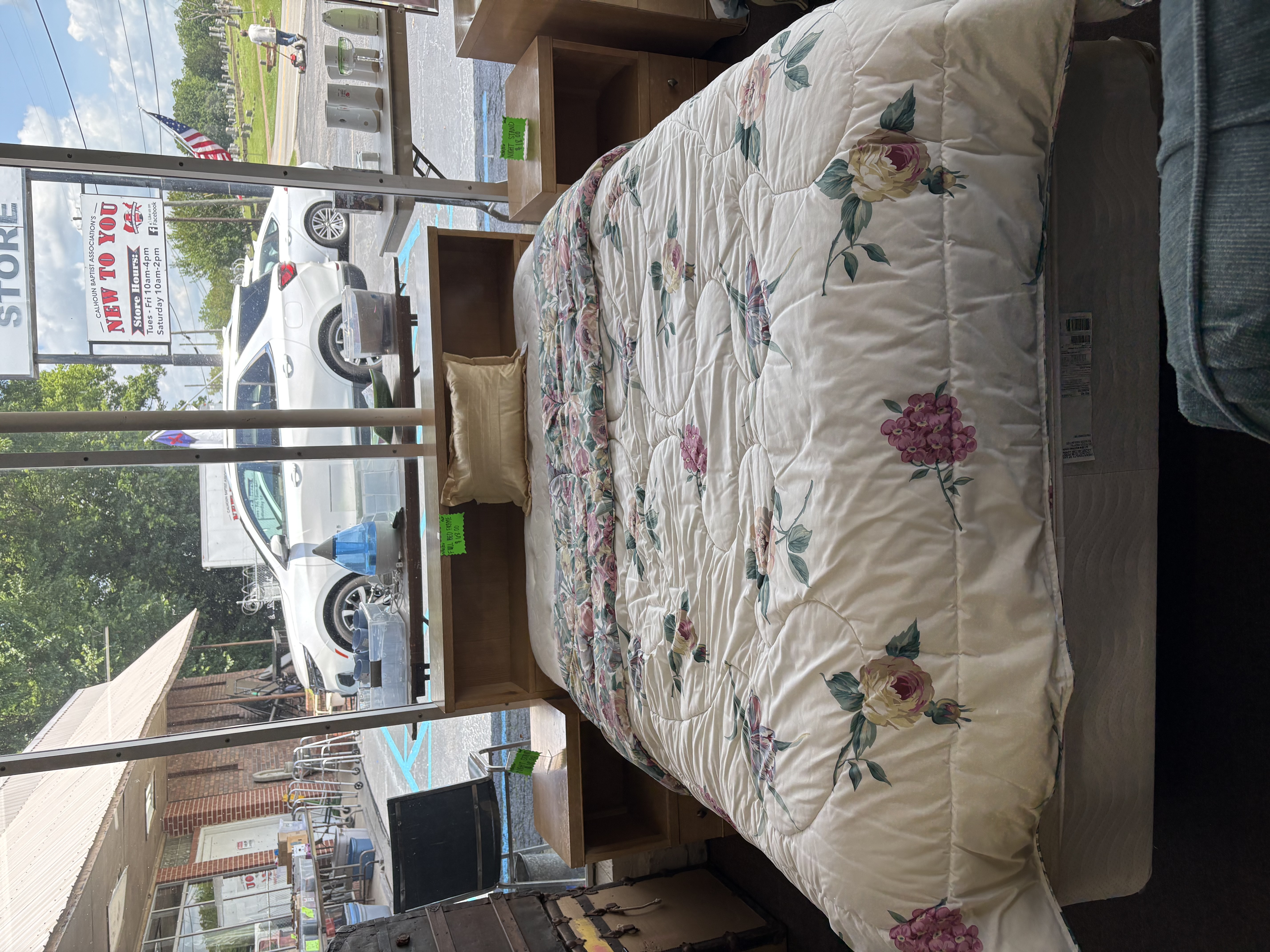 Bed with floral comforter and bookcase headboard